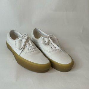 White Vans with mustard gum bottoms